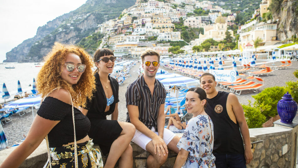 A group of people showcasing their identity on the beach.