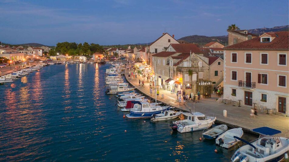 Boats docked in a harbor at dusk in croatia.