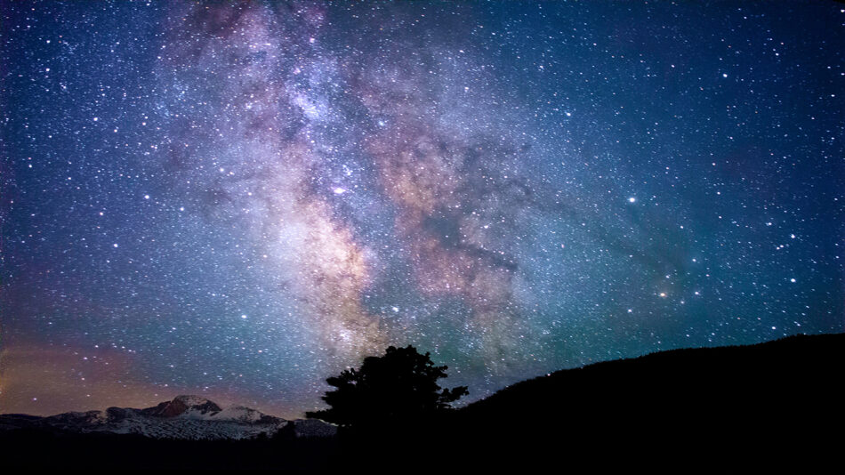 The milky above a mountain in the night sky.