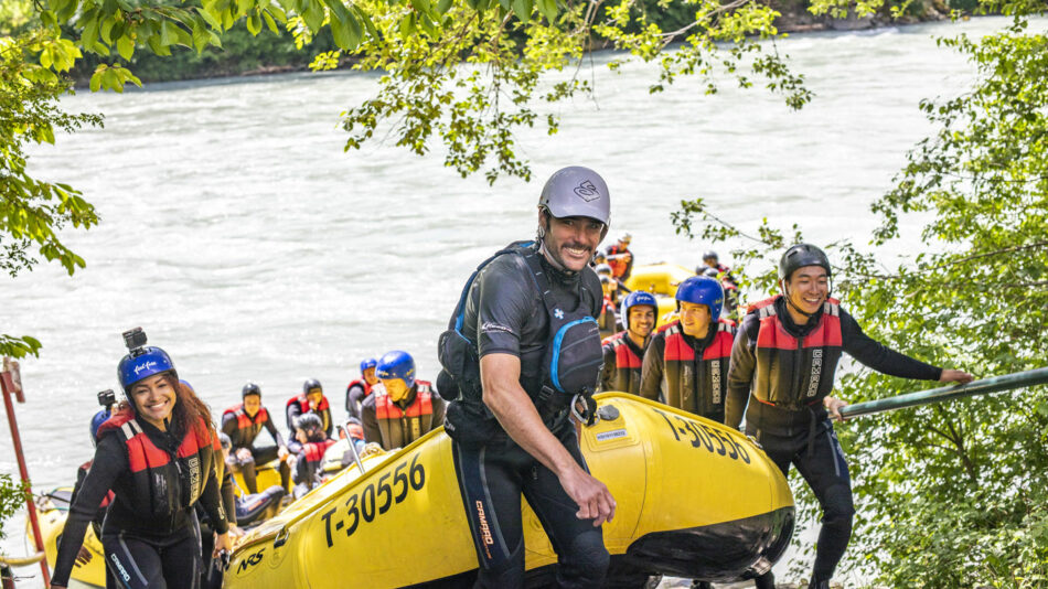 A group of people rafting down a river.