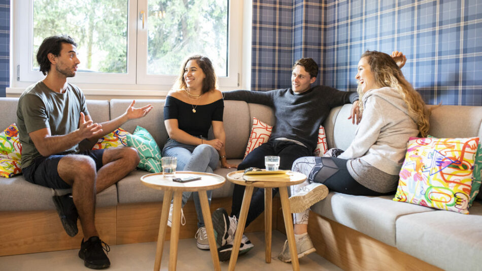 A group of people sitting on a couch in a living room.