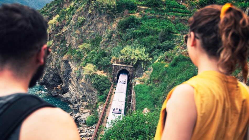 A couple admiring a boat on a cliff during their Contiki trip.