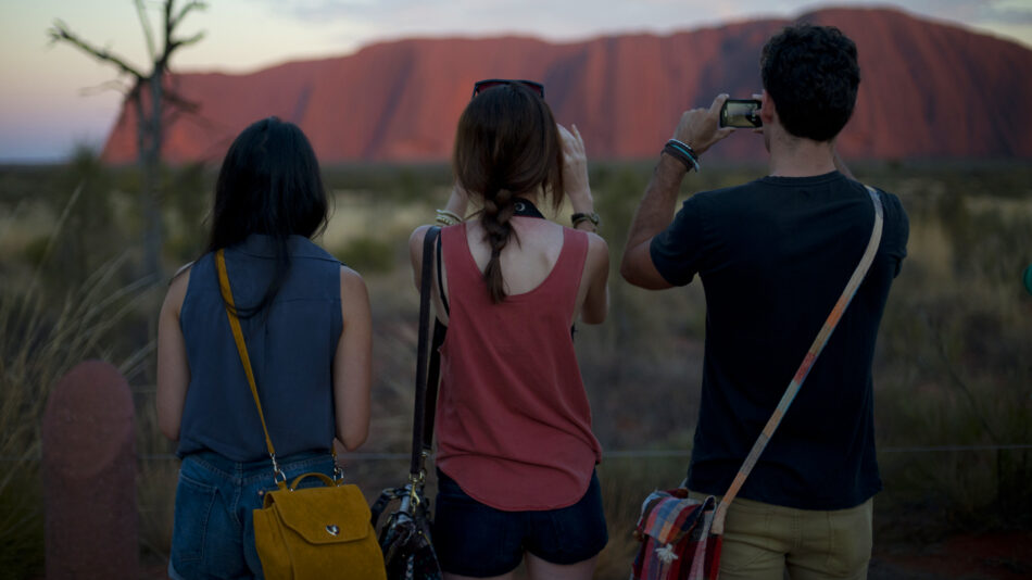 travellers photographing Uluru in Australia