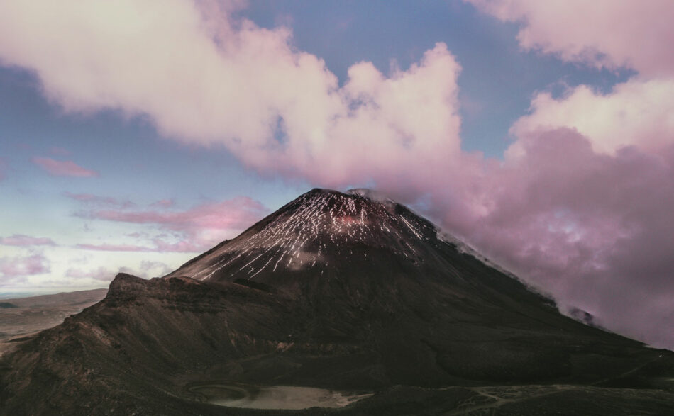 An image of a mountain with clouds in the sky.