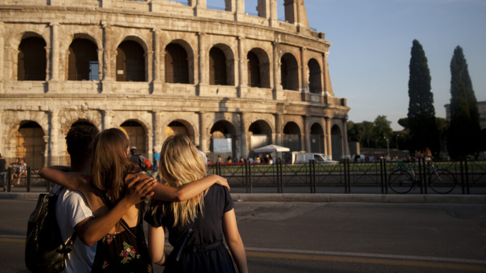 Image of three people standing outside the Colosseum