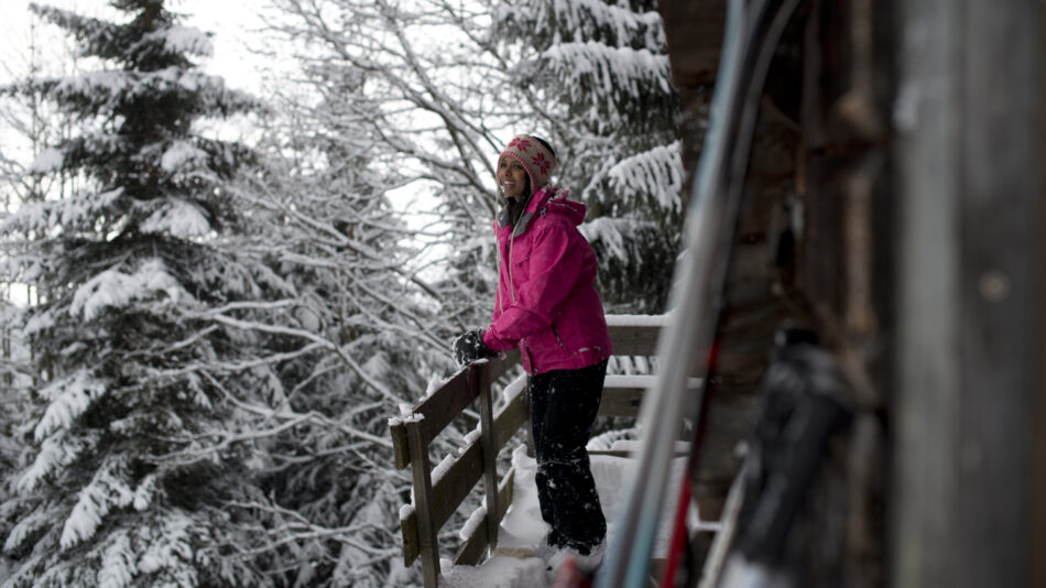 Girl in a snowy winter chalet in Austria