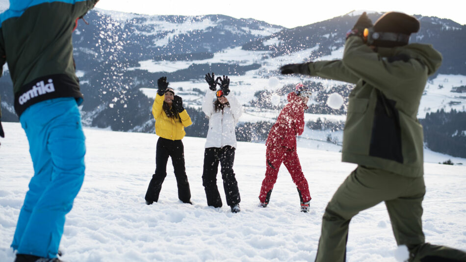 A group of people playing in the snow.