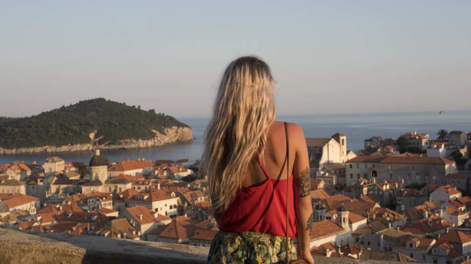 A woman admiring the world's best sunset over the city of Dubrovnik.