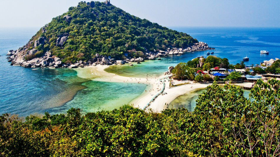 A small island surrounded by water and trees, located in Asia.