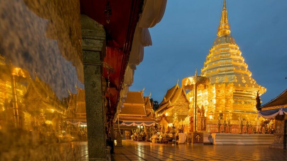 The golden pagoda on the Thai island is lit up at night.