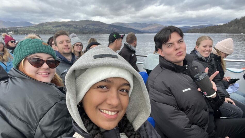 group of friends on a boat in the Lakes