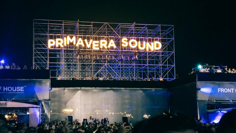 A group of people are standing in front of a sign that says Primavera Sound, one of the popular festivals in 2023.