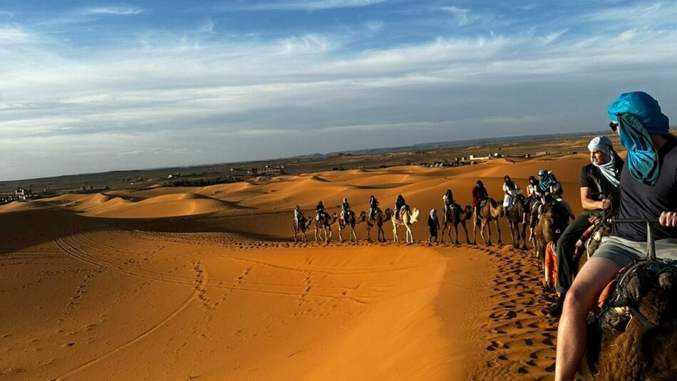 riding camels in Morroco in the desert