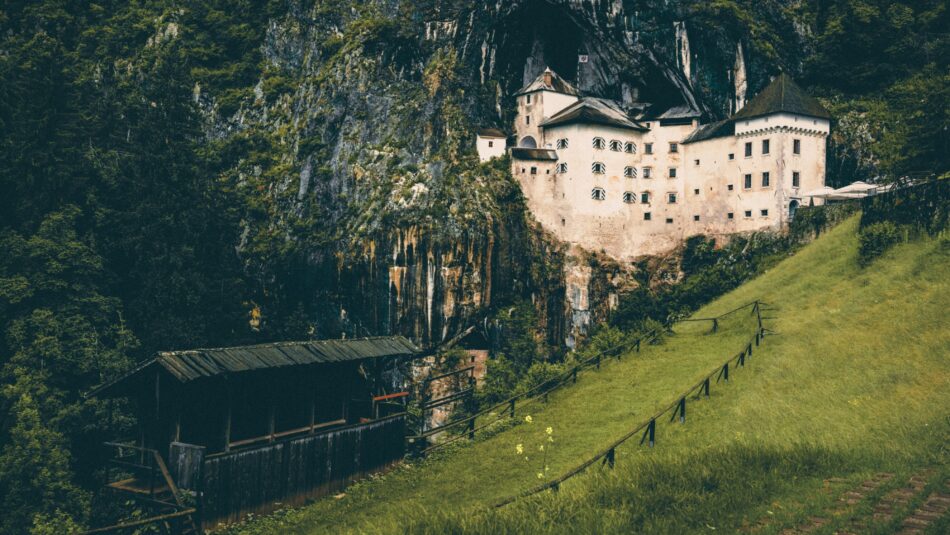 Predjama Castle built into the rock face of a cliff in Slovenia