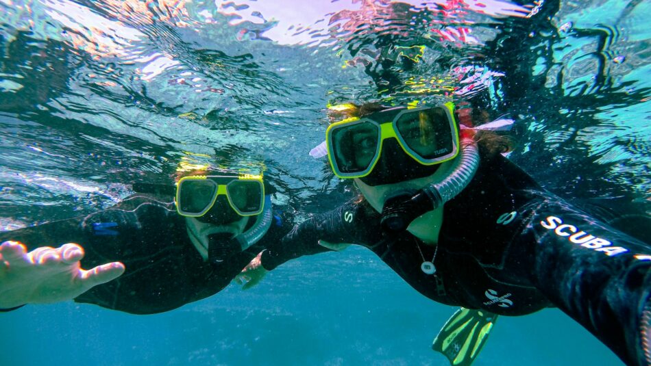 friends scuba diving in the great barrier reef, australia