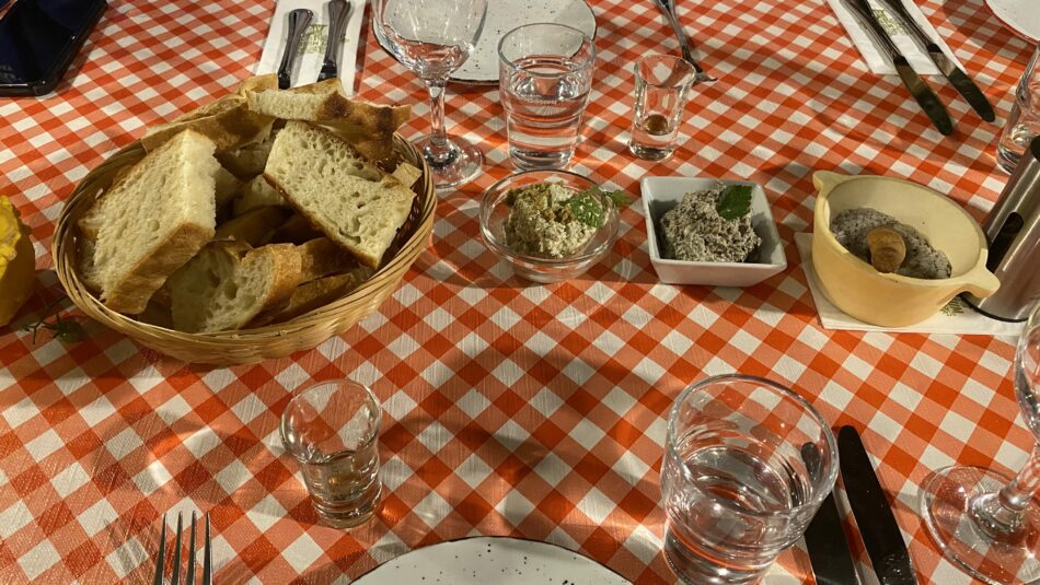 dinner table set with bread, olive tapenade, and salt in Croatia