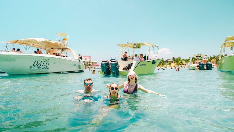 Playa del Carmen, Mexico - travellers swimming in clear waters