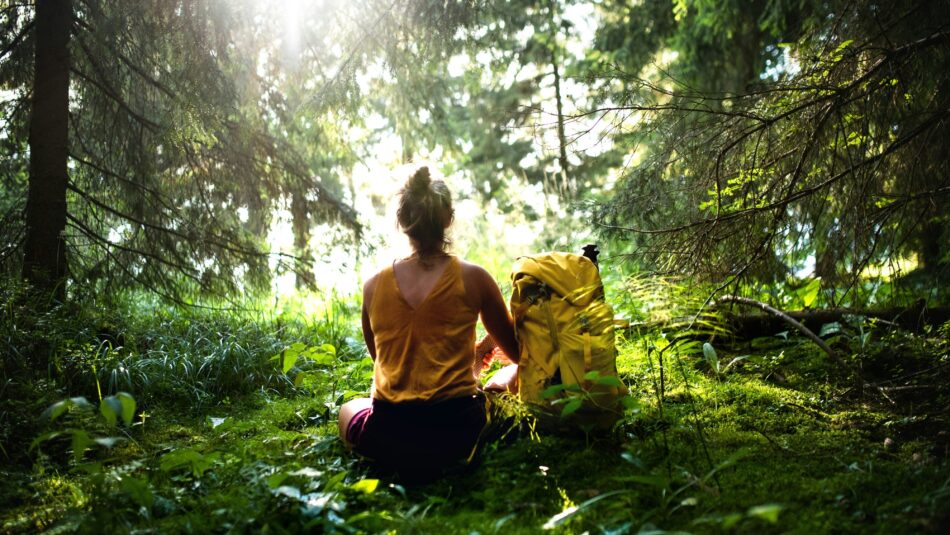 woman sitting in the forest, meditating