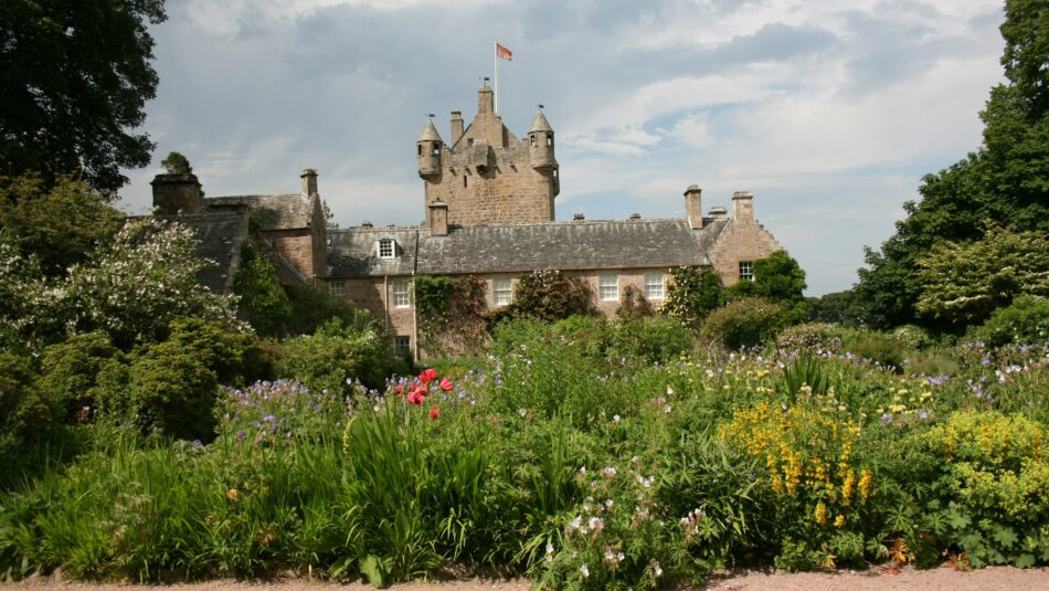 Cawdor Castle fronted by flowers and greenery in Scotland