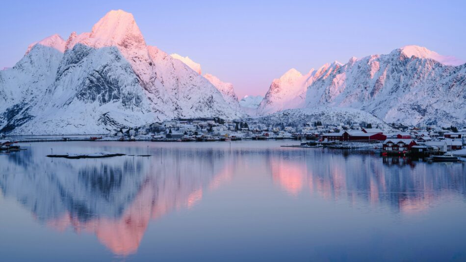 Norwegian fjords coated in blanket of snow with a small town