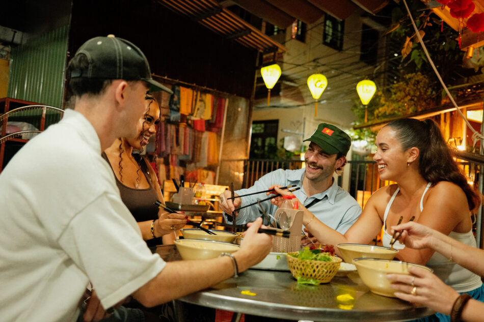 Contiki travellers in Vietnam eating food
