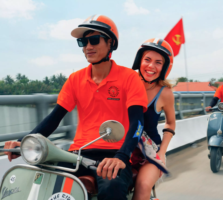 contiki traveller on back of motorbike in vietnam