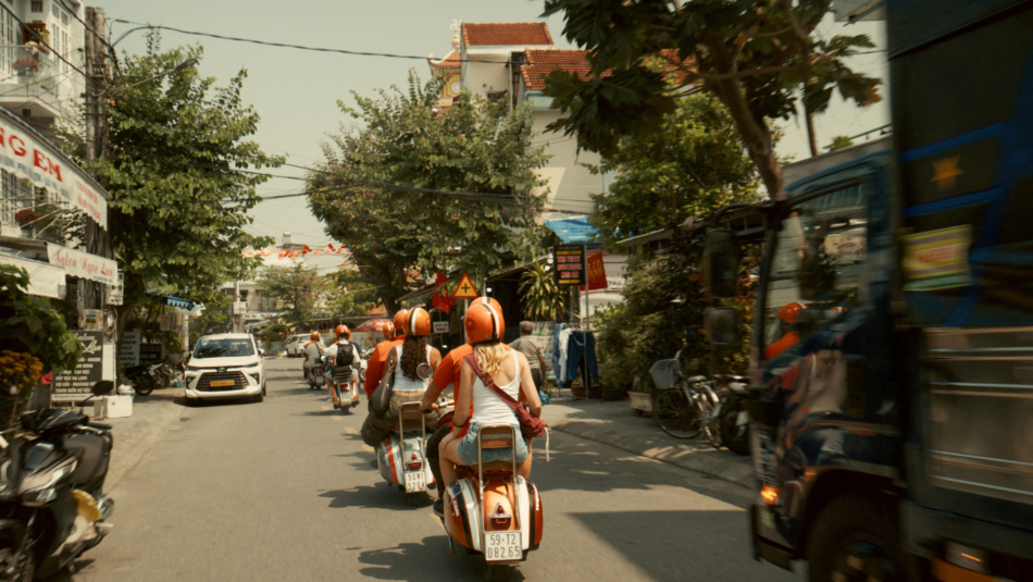 Contiki travellers on the back of vespas in Vietnam