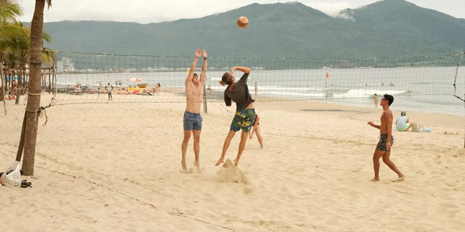contiki travellers playing volleyball at da nang vietnam