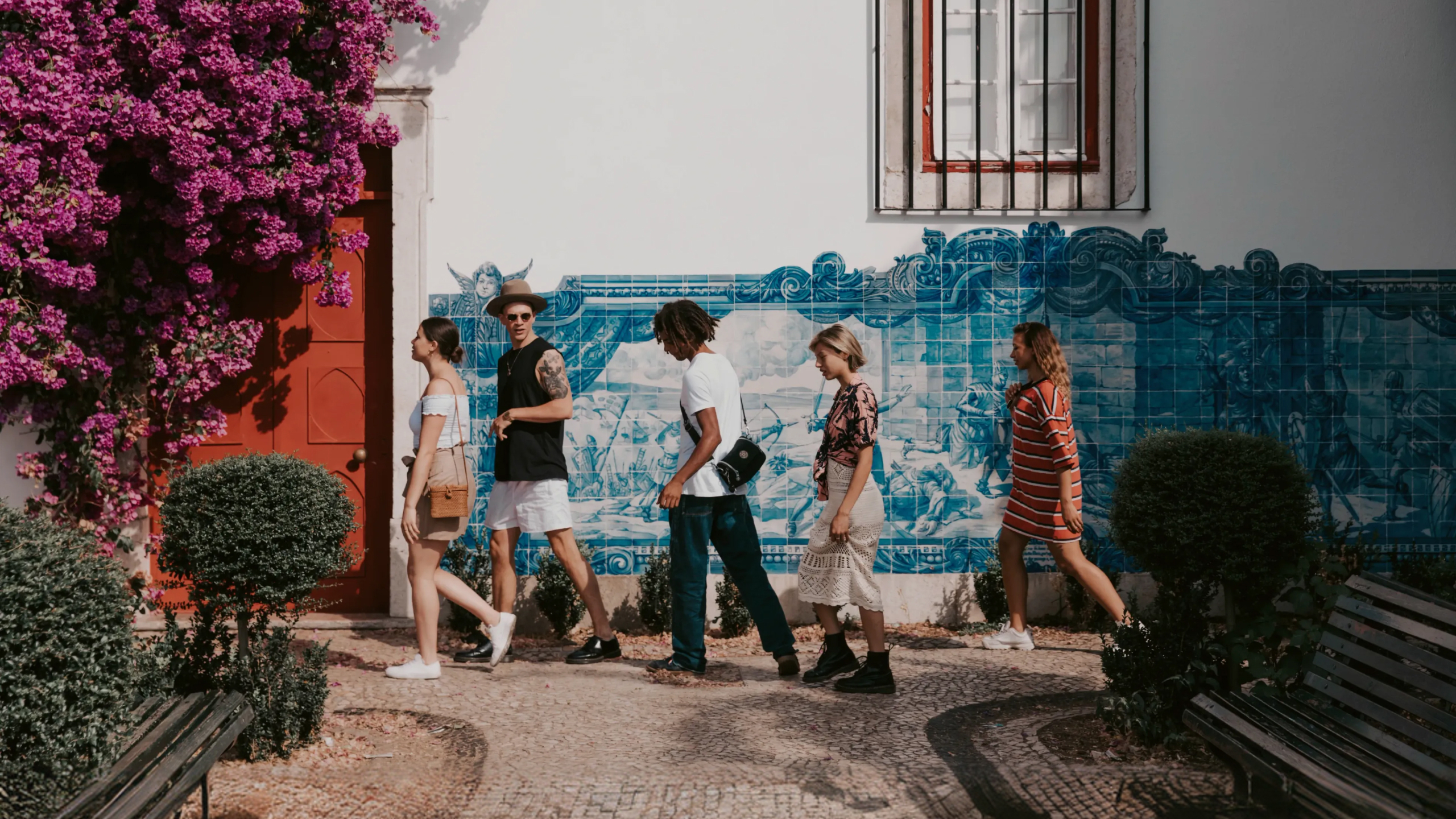 Travellers walking past traditional blue azulejo tiles in Lisbon, Portugal - Contiki Spain, Portugal & Morocco Uncovered Tour