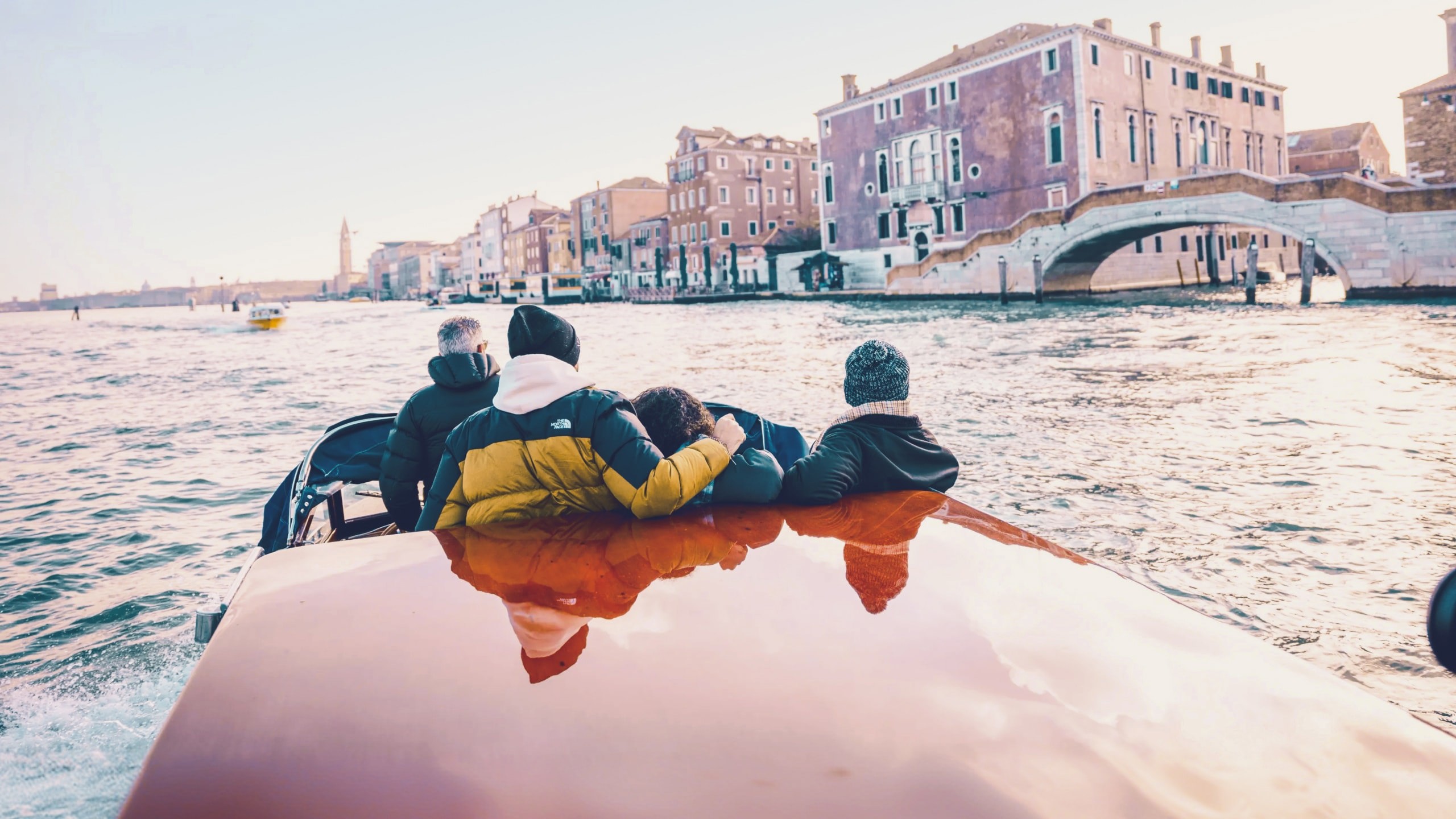 Travellers cruising through Venice by water taxi - Contiki Barcelona to London Quest Tour